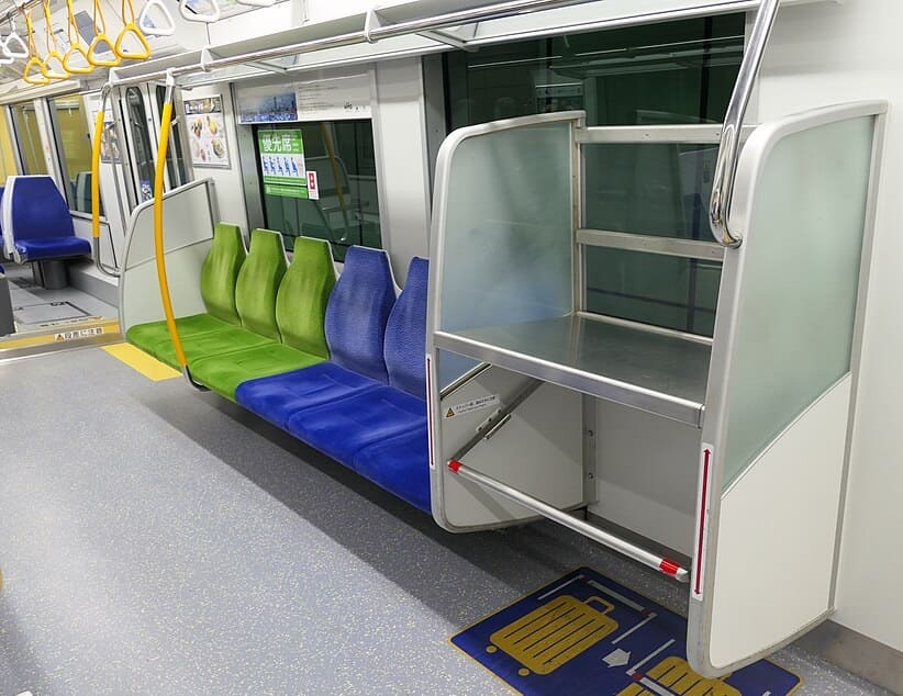 Seats and a luggage shelf inside of a monorail train.